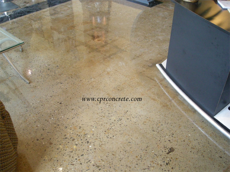 A beautiful, tan-colored, polished cement floor adorns a hair salon.